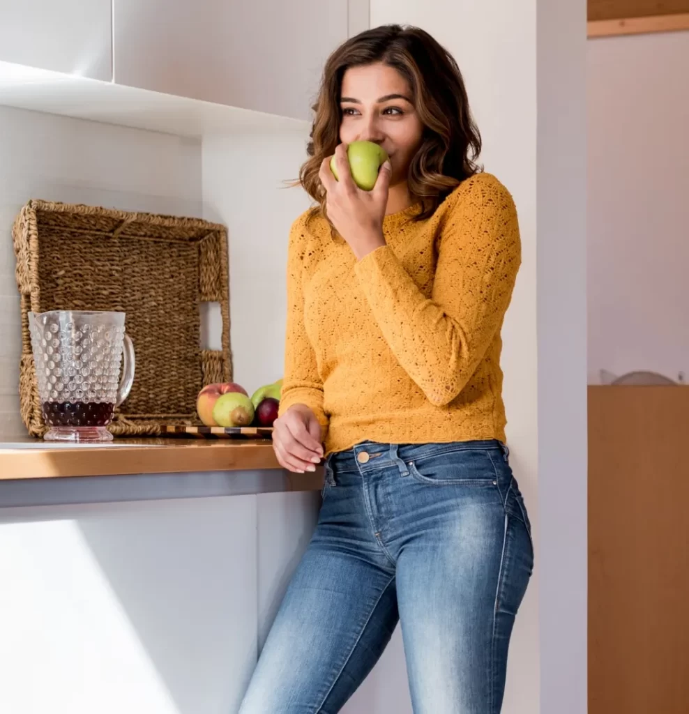 beautiful woman eating apple utc