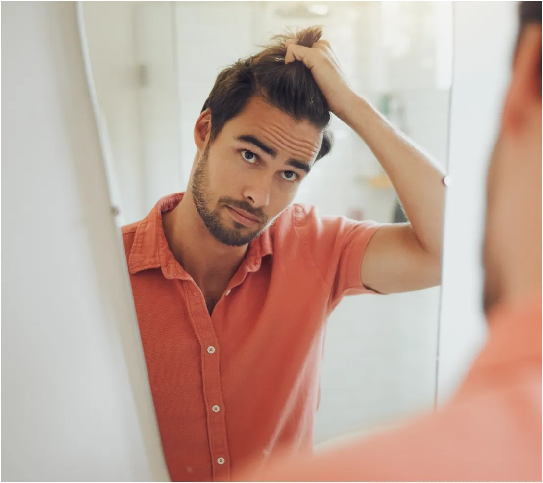 handsome young caucasian man touching his hair and utc