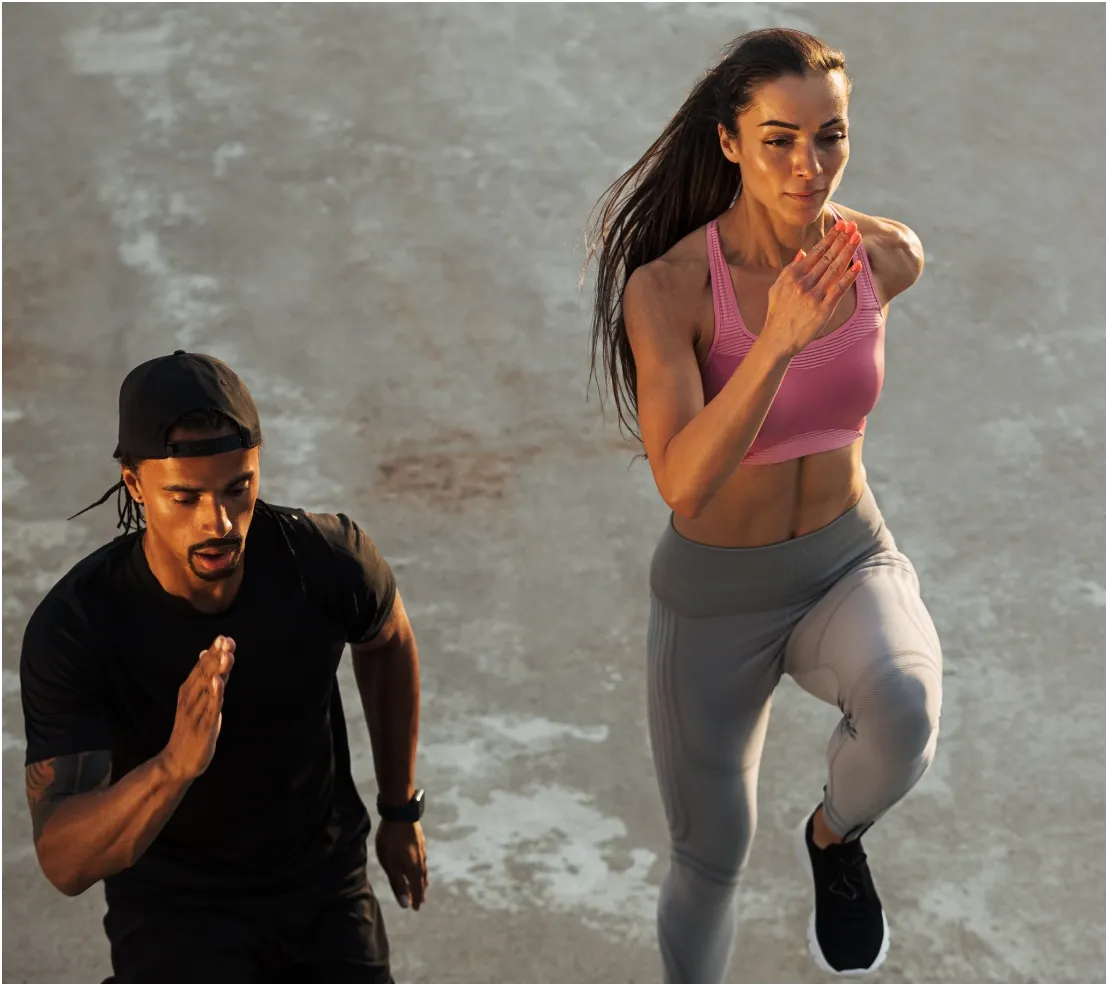 high angle of two athletes running together on the utc