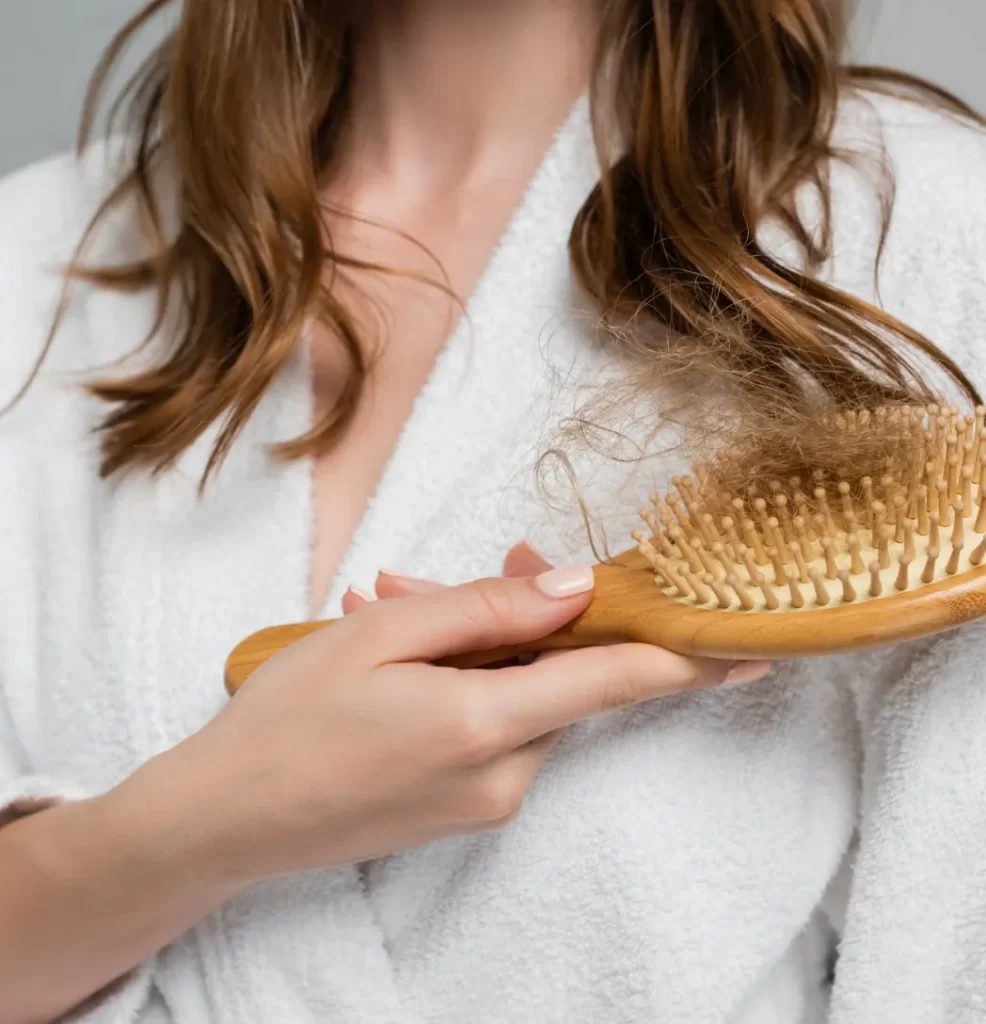 partial view of young woman holding wooden hair br utc