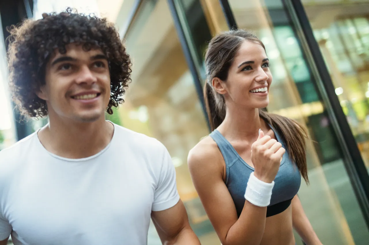 young happy fitness friends running in urban area utc